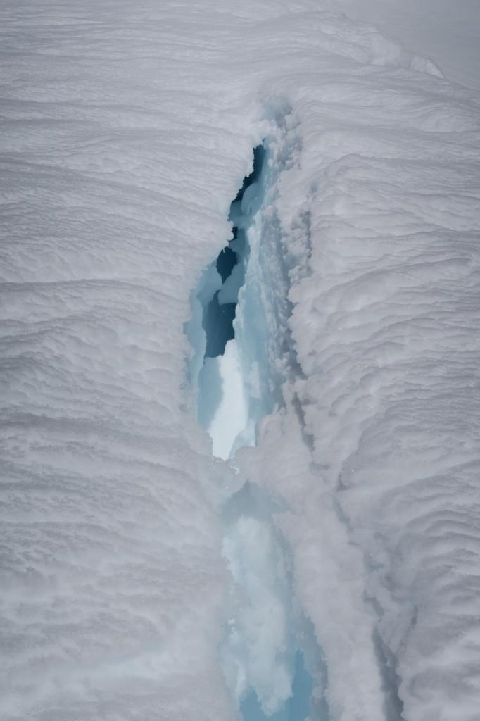  Crack behind a <a href="/avalanche-terms/cornice" title="A mass of snow deposited by the wind, often overhanging, and usually near a sharp terrain break such as a ridge. Cornices can break off unexpectedly and should be approached with caution." class="lexicon-term">cornice</a> on a south facing slope. 