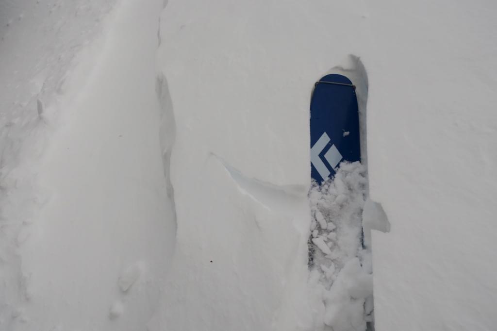  A west facing slope exhibiting <a href="/avalanche-terms/wind-slab" title="A cohesive layer of snow formed when wind deposits snow onto leeward terrain. Wind slabs are often smooth and rounded and sometimes sound hollow." class="lexicon-term">wind slab</a> development. 