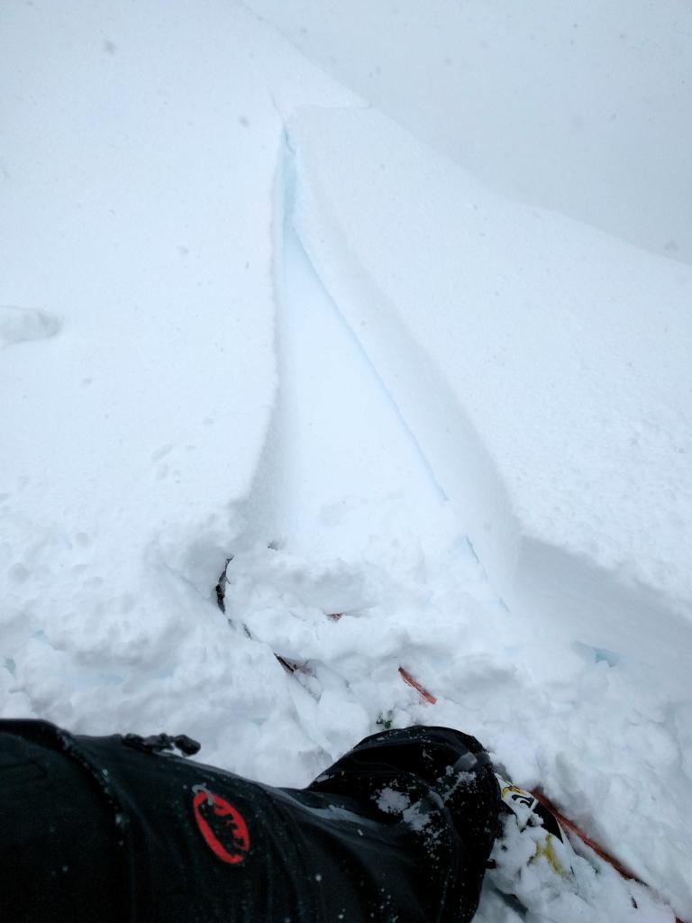  Small <a href="/avalanche-terms/wind-slab" title="A cohesive layer of snow formed when wind deposits snow onto leeward terrain. Wind slabs are often smooth and rounded and sometimes sound hollow." class="lexicon-term">wind slab</a> crack on a N-NE facing test slope at 8200 ft. 