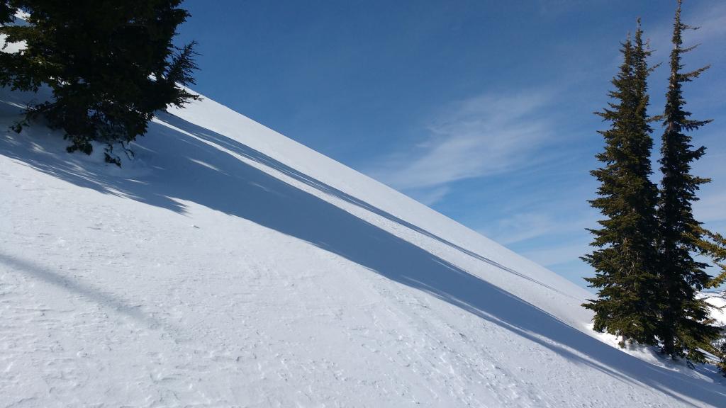  Site of testpit to examine <a href="/avalanche-terms/wind-slab" title="A cohesive layer of snow formed when wind deposits snow onto leeward terrain. Wind slabs are often smooth and rounded and sometimes sound hollow." class="lexicon-term">wind slab</a>. 