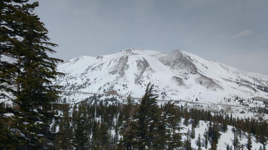  Difficult to see in photo, but minor amounts of blowing snow visible in near and above treeline areas. 