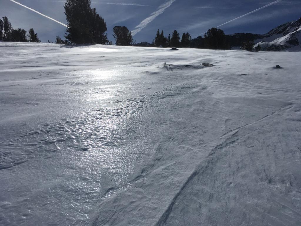  Blowing wind removing snow down to <a href="/avalanche-terms/rain-crust" title="A clear layer of ice formed when rain falls on the snow surface then freezes." class="lexicon-term">rain crust</a>. 