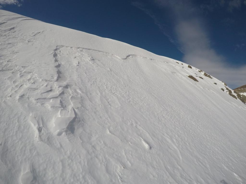  Old <a href="/avalanche-terms/crown-face" title="The top fracture surface of a slab avalanche. Usually smooth, clean cut, and angled 90 degrees to the bed surface." class="lexicon-term">crown</a> below east facing ridge 
