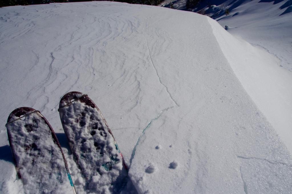  Shooting crack on obvious <a href="/avalanche-terms/wind-slab" title="A cohesive layer of snow formed when wind deposits snow onto leeward terrain. Wind slabs are often smooth and rounded and sometimes sound hollow." class="lexicon-term">wind slab</a> 