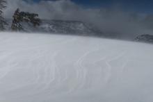 Wind affected snow and blowing snow on the summit ridge.