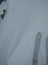 Shooting cracks on a wind loaded test slope just before a wind slab failure on that slope.