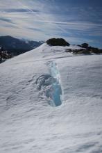 Huge crevasse where the east facing slope meets the flat ridge. 