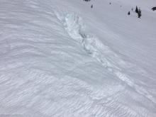 Sagging cornices have opened up large, deep cracks between cornice and ridgeline.. 