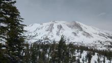 Difficult to see in photo, but minor amounts of blowing snow visible in near and above treeline areas.