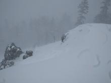 1 to 2 foot deep wind slabs failing on the old/new interface on a near treeline wind loaded slope. Triggered from lower angle terrain above the slope.