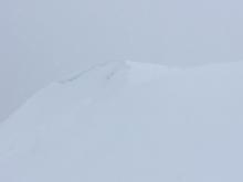 Natural wind slab/cornice release partially covered by additional snow.