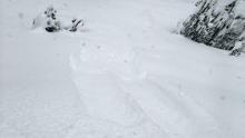 Intentional skier triggered loose dry avalanche (D1) on road cut at very bottom of Pole Cr Rd.