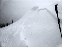 Small wind slab that propagated all the way around an E-ENE-NE facing test slope. Triggered from a low angle slope on the side.