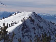 Very small amounts of blowing snow observed on foreground ridge, just above the highest trees. Transport occurring only during gusts to 60 mph. Rose Knob Peak