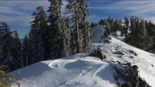 Looking south down the ridge. Scoured western slopes and small cornices on the eastern slopes