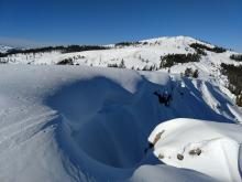 Very large cornice hanging over a steep slope.