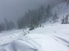 Old avalanche debris from a cornice fall that was partially covered by new snow