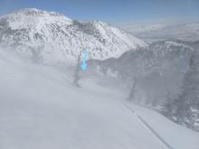 Blowing snow along a sub-ridge of Tamarack Peak. The arrow is pointing to a person standing on the ridge.