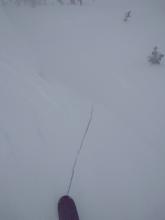 Skier triggered shooting crack 20 ft long and 1 ft deep in wind slab on test slope.