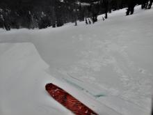 Skier triggered cornice failure on a a test slope did not produce signs of instability in the wind slab on the test slope.