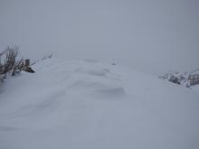 Old cornice/wind pillow scoured back by NE winds on top of N-S oriented ridgetop.