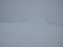 Looking along the Mt. Judah ridgeline with blowing snow and limited visibility. 