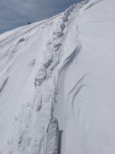 Raised ski tracks on an E aspect near the summit ridgeline
