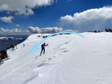 Scoured area along the ridge with a deposition zone for wind transported snow below the skier. The arrow shows the direction that the wind transported the snow during the recent storm.