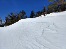 Wind sculpting and scouring exposing a firm crust along the ridge from the NE winds.