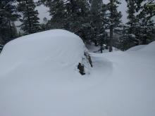 Wind channel formed around the rock below the treeline. The channel is south of the rock