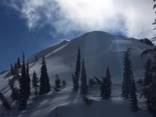 Active wind loading continuing over the higher ridges and peaks.