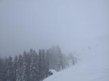 Poor visibility looking into the larger avalanche terrain.