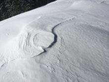 Overview of ridge conditions (from R to L): scoured surfaced on bottom right, then some new snow showing signs of erosion, then wind deposited snow. 