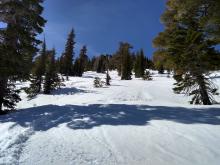 Transitional soft snow on east aspects below peak.