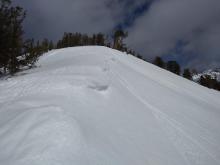 Drooping cornices with icicles from previous melt.