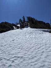 Some firm uneven snow surfaces near the summit of Rubicon on wind-exposed N aspects at 10:30 am.