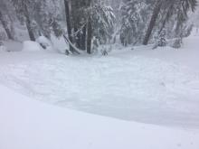 Intentionally triggered wind slab avalanche with a small cornice drop.