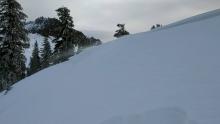 Some snow blowing onto a small wind loaded test slope on the Castle Peak Ridge