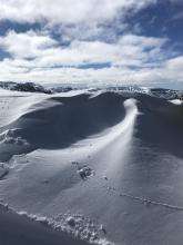 Interesting snow formation at top of Waterhouse. Looks like a prevailing southern wind, combined with some swirling at the peak, shaped the snow here into a wave shape. 