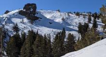 Wind scoured surfaces and raised ski tracks on an exposed NE slope