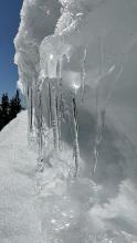 Icicles dripping off a small cornice.