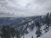 Thick cloud cover moving in at 11 am. Snow showers visible in the distance towards South Lake Tahoe.