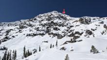 Overview of the slope the victim fell down. The arrow is where the person broke the cornice.