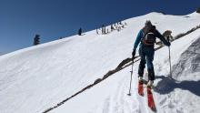 Looking acorss at wind-scoured snow and raised tracks on E and NE aspects. 