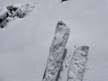 Clumping snow on skis.