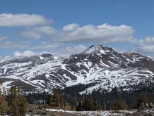 Cloud cover building over Red Lake and Stevens Peaks. Patch skiing season on their S and W aspects