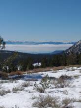 Warm day at elevation with robust inversion clouds still holding over Lake Tahoe at midday.