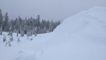 Wind-loaded test slope on Andesite Peak. Ski kicks released small pieces of cornice that then triggered small sluffs in the new snow on this slope. It looked like there was buried debris at the bottom of the slope indicating that it had avalanched sometime during the storm. 