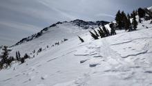 Wind sculpted surfaces on exposed N and NE aspects at the upper elevations.