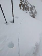 Cracking in the new wind loaded snow on a wind-loaded test in exposed upper elevation terrain.